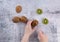 ripe green kiwi fruits on a light gray marble kitchen table