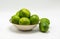 Ripe green limes in a small bowl