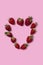 Ripe heart shaped strawberries on a pink background. Love concept. Valentine`s day concept