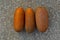 Ripe Indian Cucumber on a concrete background. Kerala orange cucumber for vishu kani vellari. Also called Vellarika in Malayalam