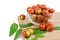 Ripe jojoba fruits in a bowl on a wooden tabletop. Chinese date fruit