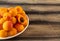 Ripe juicy apricot in a plate on a wooden table