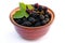 Ripe juicy blackberries in a clay bowl isolated