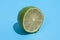 Ripe juicy delicious lime on blue background. Healthy eating and dieting concept