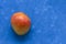 Ripe juicy fruit of the Brazilian mango from the tropics on a blue background with place for text. Exotic fresh fruits