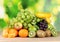 Ripe juicy fruits on wooden table on green