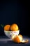 Ripe, juicy, natural tangerine fruits on a dark background.