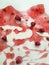 Ripe juicy raspberries of deep saturated raspberry color floating in raspberry jelly with milk on a white background as a visual e