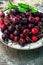 Ripe large cherries in the iron bowl iron
