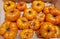 Ripe large orange tomatoes collected from a home garden and stacked in a tray