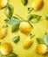 Ripe lemons on branch with green leaves at yellow background. Creative. Summer Pattern. Trendy fruits