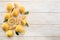 Ripe lemons and lemon leaves on wooden background. Top view.