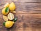 Ripe lemons and lemon leaves on wooden background. Top view.
