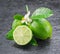 Ripe lime fruits on the gray background.