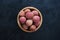 Ripe lychees on a black table. Top view.