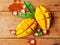 Ripe mango cut in dice shape on wooden table.