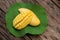 Ripe mango fruits on lotus green leaves and on an old wood background.top view,flat lay