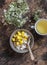 Ripe mango, granola greek yogurt and green tea - delicious breakfast, brunch on a wooden background top view