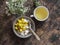 Ripe mango, granola greek yogurt and green tea - delicious breakfast, brunch on a wooden background top view