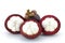 Ripe mangosteens Garcinia mangostana or half mangosteen with green leaves isolated on the white background