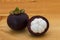 Ripe mangosteens Garcinia mangostana or half mangosteen on a wooden table