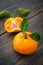 Ripe orange clementine tangerine fruit with green leaves