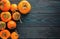 Ripe, orange, juicy persimmons on a wooden old, textured background. Top view. Flat lay