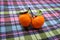 Ripe orange mandarins tangerines with green leaves on a textile multicolored colorful tablecloth. Fruit, citrus, tropical, health