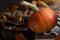 Ripe orange pumpkin stand on old books on the windowsill against the background of decor. Autumn concept