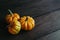 Ripe orange pumpkins on a dark wooden background. Minimalistic concept for Thanksgiving card or background
