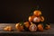 ripe orange tangerines with leaves lie on a table and a clay stand on a soft background on an old wooden table. side view with