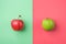 Ripe Organic Apples on Split Duotone Green Red Cherry Pink Background. Styled Creative Image. Vitamins Summer Vegan