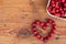 Ripe organic homegrown cherries on wooden background in heart shape