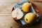 Ripe organic pears in earthenware dish on vintage wooden table