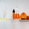 Ripe organic persimmon fruit and persimmon extract in cosmetic bottle with dropper. Abstract chemical or cosmetic