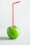 Ripe Organic Whole Green Apple with Drinking Straw Imitation of Glass Bottle with Freshly Pressed Juice. Healthy Diet Drink Detox