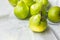 Ripe organic yellow green pears on white cotton table cloth in kitchens. Autumn fall harvest local bio produce vitamins