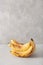 Ripe overripe organic bananas on concrete background. ugly food zero waste concept