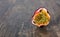 Ripe passion fruit sliced in halve close-up on brown surface