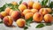 Ripe peaches with green leaves on a white background.