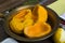 Ripe peeled pumpkin, cut into pieces, lies in a copper pan for making jam