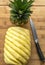 Ripe perfectly peeled pineapple, on a wooden background