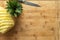 Ripe perfectly peeled pineapple, on a wooden background