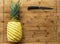 Ripe perfectly peeled pineapple, on a wooden background.