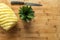 Ripe perfectly peeled pineapple, on a wooden background