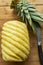 Ripe perfectly peeled pineapple, on a wooden background