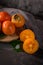 Ripe persimmon fruits in a cork plate