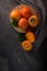 Ripe persimmon fruits in a cork plate