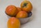 Ripe persimmons on a rustic plate