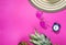 Ripe pineapple, coconut, glasses and hat on pink background. Vacation concept